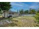 Backyard view showing the home's exterior with an AC unit and a view of the fenced perimeter at 211 80Th N Ave, St Petersburg, FL 33702