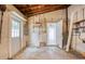 Unfinished basement with a side door, water heater, and shelving offering potential for customization at 211 80Th N Ave, St Petersburg, FL 33702