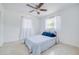 Cozy bedroom featuring neutral walls, updated ceiling fan, and window at 211 80Th N Ave, St Petersburg, FL 33702