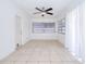 Well-lit room with tile flooring, a ceiling fan, and curtains covering a pair of windows at 211 80Th N Ave, St Petersburg, FL 33702