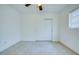 This bright bedroom features neutral walls, a ceiling fan, and a double door closet at 211 80Th N Ave, St Petersburg, FL 33702