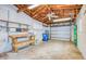Spacious garage with a work bench, storage shelves, and a ceiling fan providing ample space for projects and storage at 211 80Th N Ave, St Petersburg, FL 33702