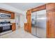 This kitchen features stainless steel appliances, wood cabinets, granite counters, and a gas range at 211 80Th N Ave, St Petersburg, FL 33702