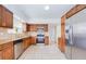 This kitchen features stainless steel appliances, wood cabinets, granite counters, and a gas range at 211 80Th N Ave, St Petersburg, FL 33702
