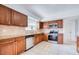 Updated kitchen boasts stainless steel appliances, granite counters, tile backsplash, and wood cabinetry at 211 80Th N Ave, St Petersburg, FL 33702