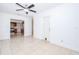 Open floor plan living room featuring tile flooring and a ceiling fan with easy access to the kitchen at 211 80Th N Ave, St Petersburg, FL 33702