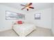 Bright main bedroom featuring two windows, a ceiling fan and neutral colored walls at 211 80Th N Ave, St Petersburg, FL 33702