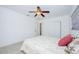 Bright main bedroom featuring a ceiling fan, neutral colored walls, and a large window at 211 80Th N Ave, St Petersburg, FL 33702
