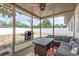 Back porch with wicker furniture, a table, and a grill overlooks a fenced-in backyard at 2153 Pocahontas Dr, Largo, FL 33774