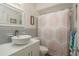 Bathroom features a modern vessel sink, white vanity, tile backsplash, and a shower with decorative curtain at 2153 Pocahontas Dr, Largo, FL 33774