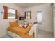 Bedroom with a daybed, pullout drawers, and orange curtains; natural light shines in from the windows at 2153 Pocahontas Dr, Largo, FL 33774