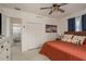 Bedroom with hardwood floors, closet, ensuite bathroom, and comfortable decor in a bright and open space at 2153 Pocahontas Dr, Largo, FL 33774