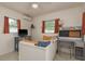 Bedroom with television, desk, AC unit, and two windows that provide ample natural light at 2153 Pocahontas Dr, Largo, FL 33774