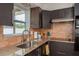 Kitchen featuring granite countertops, a stainless steel sink, modern lighting, and ample cabinet space at 2153 Pocahontas Dr, Largo, FL 33774