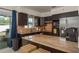 Modern kitchen with a kitchen island, stainless steel appliances, and beautiful backsplash under modern lighting at 2153 Pocahontas Dr, Largo, FL 33774