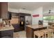 Well-lit kitchen featuring granite countertops, stainless steel appliances, and island seating at 2153 Pocahontas Dr, Largo, FL 33774