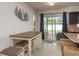 Bright and modern kitchenette featuring a bar-height table and seating, and a sliding glass door to the outside at 2153 Pocahontas Dr, Largo, FL 33774