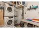 Laundry room featuring a stacked washer and dryer, utility sink, and folding table at 2153 Pocahontas Dr, Largo, FL 33774