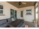 Covered patio with ceiling fan, sliding glass door, and cushioned wicker furniture with wood table at 2153 Pocahontas Dr, Largo, FL 33774