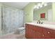 Well-lit bathroom with a combination tub and shower, vanity with white countertop, and tiled floor at 2228 Swedish Dr # 22, Clearwater, FL 33763
