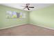 Inviting bedroom with neutral carpeting, ceiling fan, and a bright window at 2228 Swedish Dr # 22, Clearwater, FL 33763