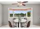 Bright breakfast nook featuring a round glass table, charming window, and relaxing lake view at 2228 Swedish Dr # 22, Clearwater, FL 33763