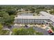 Condo building with ample parking overlooking a serene lake and lush trees at 2228 Swedish Dr # 22, Clearwater, FL 33763