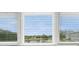 Serene lake view from the home's window with lots of beautiful sky and trees at 2228 Swedish Dr # 22, Clearwater, FL 33763
