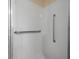 Bright tiled shower with white subway tile and brushed metal hand rails at 2228 Swedish Dr # 22, Clearwater, FL 33763