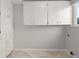 Utility room with white cabinetry and tile flooring, offering ample storage and functionality at 2228 Swedish Dr # 22, Clearwater, FL 33763