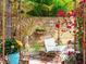 Backyard patio with a comfortable lounge chair, flowering plants, and decorative wall, creating a relaxing and private outdoor retreat at 246 22Nd Ne Ave, St Petersburg, FL 33704
