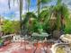 A serene backyard with a seating area surrounded by tropical plants and foliage, perfect for outdoor relaxation and entertaining at 246 22Nd Ne Ave, St Petersburg, FL 33704