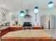 Well-lit kitchen with stainless steel appliances, wood countertops, pendant lights, and ample counter space at 246 22Nd Ne Ave, St Petersburg, FL 33704