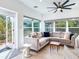 Bright living area with a comfortable sofa, large windows, and a view of the lush garden at 246 22Nd Ne Ave, St Petersburg, FL 33704