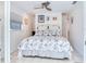 Airy main bedroom with ceiling fan, tiled floor, and floral comforter at 246 22Nd Ne Ave, St Petersburg, FL 33704