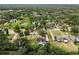 An elevated view highlighting the backyard oasis in a serene neighborhood surrounded by lush greenery and mature trees at 2512 Rustic Oaks Dr, Lutz, FL 33559