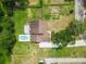 Overhead view of a home with a pool, patio, and large backyard surrounded by greenery at 2512 Rustic Oaks Dr, Lutz, FL 33559
