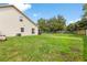 Large backyard with healthy grass and two story house at 2512 Rustic Oaks Dr, Lutz, FL 33559