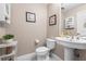 Cozy powder room features neutral walls, pedestal sink, and decorative accents at 2512 Rustic Oaks Dr, Lutz, FL 33559