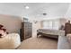 Bedroom with a bean bag chair, dresser, carpet, TV, and a floral bed spread at 2512 Rustic Oaks Dr, Lutz, FL 33559
