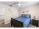 Cozy bedroom features a ceiling fan, closet, and light beige walls with blue botanical bedding at 2512 Rustic Oaks Dr, Lutz, FL 33559