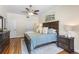 Bright bedroom features a dark wood bed frame, hardwood floors, and a ceiling fan at 2512 Rustic Oaks Dr, Lutz, FL 33559