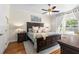 Spacious bedroom boasts hardwood floors, a ceiling fan, and large window views at 2512 Rustic Oaks Dr, Lutz, FL 33559