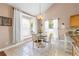 Cozy dining area with a round table, surrounded by windows and natural light at 2512 Rustic Oaks Dr, Lutz, FL 33559