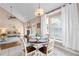Bright dining area with chandelier and large windows, seamlessly connected to the living room at 2512 Rustic Oaks Dr, Lutz, FL 33559