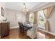 Bright dining room with chandelier, wood table, and backyard views at 2512 Rustic Oaks Dr, Lutz, FL 33559
