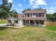 Charming two-story home with a welcoming front porch and manicured lawn at 2512 Rustic Oaks Dr, Lutz, FL 33559