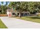 Lovely two-story home featuring an attached garage and a large, paved driveway at 2512 Rustic Oaks Dr, Lutz, FL 33559