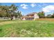 Charming two-story home with a welcoming front porch and a green lawn at 2512 Rustic Oaks Dr, Lutz, FL 33559