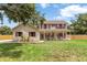 Charming two-story home with a welcoming front porch and red shutters at 2512 Rustic Oaks Dr, Lutz, FL 33559